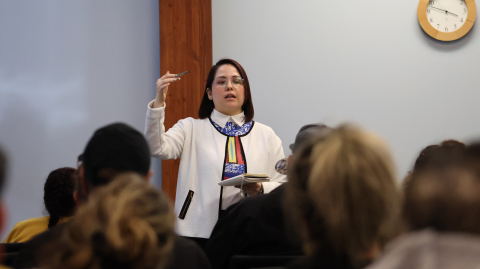 Maria Arriaga talking to large group