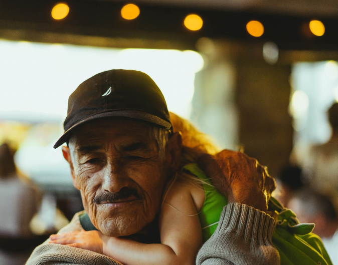 latino gentleman holding child