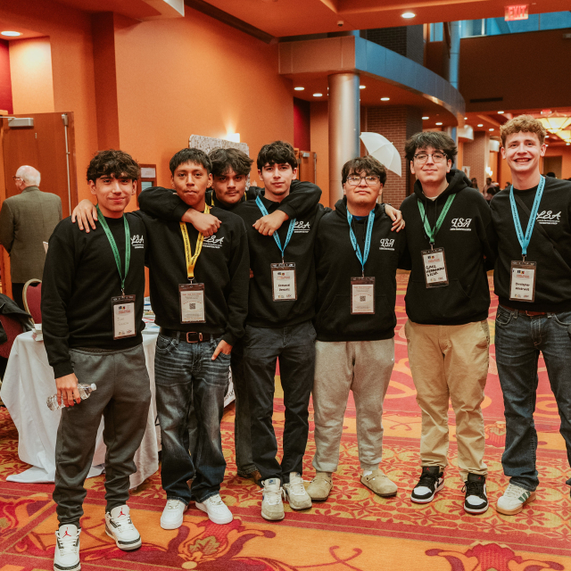 Students pose for picture in hallway