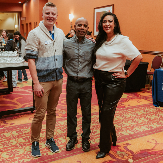 Vendors pose with MC Kristin Diaz